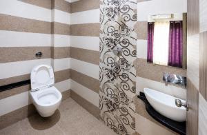 a bathroom with a toilet and a sink at Hotel City Palace in Varanasi +24 photos