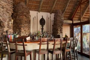 a bar in a room with a table and chairs at Nedile Lodge in Vaalwater
