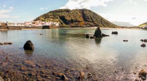 a large body of water with a mountain in the background at Hospetur 2 in Horta