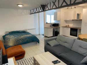 a living room with a couch and a bed at Eiffel in Haubourdin
