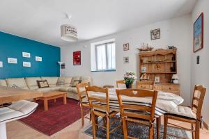 a living room and dining room with a table and chairs at La maison de Léandre - Medoc in Saint-Seurin-de-Cadourne