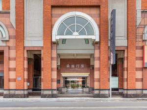 a large brick building with an entrance with a window at Guide Hotel Hsinchu Zhongyang in Hsinchu City