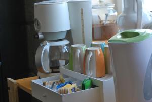 a kitchen with a coffee maker and a mixer at Secco's Seaview Accommodation in Mġarr