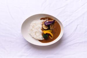 a white bowl of food with rice and vegetables at Hotel FLOW in Misato