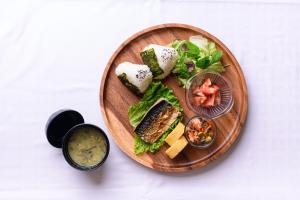 a plate of food with a sandwich and a salad at Hotel FLOW in Misato
