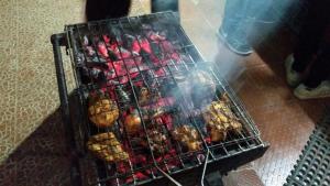 a metal cage filled with different types of food at Sholanest Mud House and Farm Stay in Vattavada Near Munnar in Vattavada