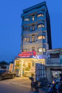 a tall building with motorcycles parked in front of it at Hotel Dharam Villa By Jai Guru Ji At Sector 11, Noida in Noida