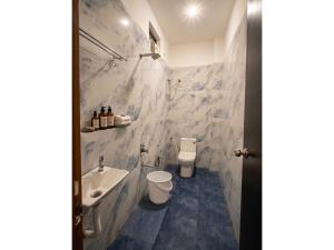 a white bathroom with a sink and a toilet at Hotel Prime Access Inn in Indore +16 photos