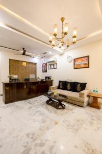 a living room with a couch and a table at Hotel Dharam Villa By Jai Guru Ji At Sector 11, Noida in Noida