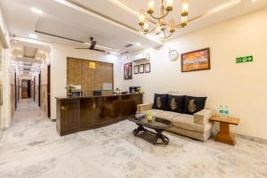 a living room with a couch and a table at Hotel Dharam Villa By Jai Guru Ji At Sector 11, Noida in Noida