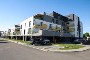 a large building with cars parked in a parking lot at AMA Residence Premium Apartment in Târgu-Mureş
