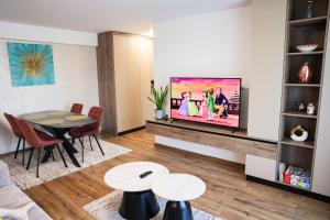 a living room with a flat screen tv on a wall at AMA Residence Premium Apartment in Târgu-Mureş