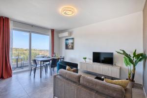 a living room with a couch and a television at Modern Maisonette with Valley Views KARP1-3 in San Ġwann