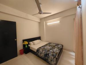 a bedroom with a bed and a ceiling fan at World Beach Resort in Cox's Bazar
