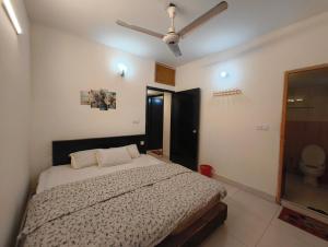 a bedroom with a bed and a ceiling fan at World Beach Resort in Cox's Bazar