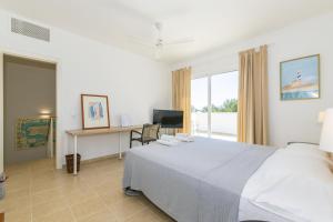 a bedroom with a bed and a desk with a computer at Biniancolla Ginesta in Biniancolla