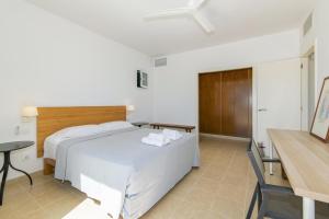 a bedroom with a white bed and a table and a desk at Biniancolla Ginesta in Biniancolla +37 photos