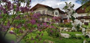 a house with purple flowers in the yard at Leierhof Karlotta in Rodengo