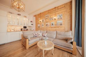 a living room with a couch and a table at Sunset Lovers Residence in Liepāja