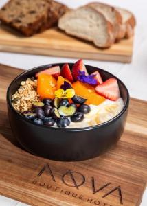 a bowl of fruit and nuts on a wooden plate at Terra Nova Suites and Spa in Gqeberha +15 photos