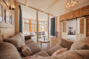 a living room with a couch and a table at Sunset Lovers Residence in Liepāja