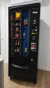 a large black refrigerator with its door open at Hostel Casa Vargas Figueroa in Cáceres