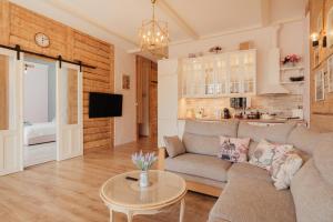 a living room with a couch and a table at Sunset Lovers Residence in Liepāja