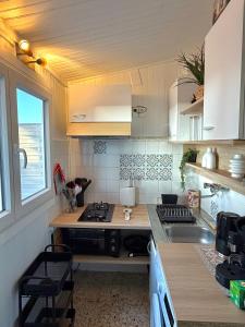 a small kitchen with a sink and a stove at casa serena in Lumio
