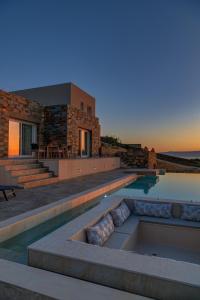 a villa with a swimming pool and a house at La VILLA DELLE TORRI in Ermoupoli