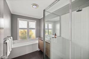 a bathroom with a shower and a tub and a sink at Rileystone in Margaret River Town +53 photos