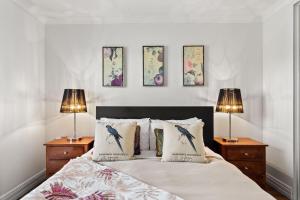 a bedroom with a bed with three pictures on the wall at Rileystone in Margaret River Town