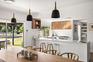 a kitchen with a table and chairs and a counter top at Rileystone in Margaret River Town