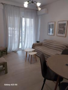 a living room with a bed and a table at Menidi Sea View 302 in Menídion