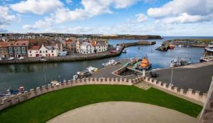 a view of a harbor with a boat in the water at Iris - D6 in Eyemouth