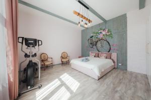 a bedroom with a bed and a bike on the wall at Sunset Lovers Residence in Liepāja +29 photos