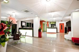 a living room with a couch and a table at Hotel San Carlo in Cesenatico