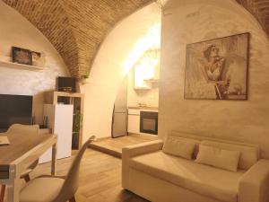 a living room with a white couch and a table at Mercato29Home in Lucera