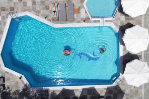 an overhead view of two people swimming in a swimming pool at Hotel Evridiki in Fourka +56 photos