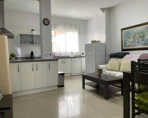 a kitchen and living room with a couch and a table at KAIROS HOME y Garaje , Algemesí Home in Algemesí