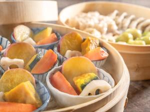 a group of containers filled with fruit and vegetables at HOTEL MYSTAYS Soga in Chiba