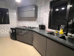 a kitchen with a sink and a stove top oven at Akany Fitahiantsoa in Ivato