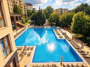 an overhead view of a large swimming pool with lounge chairs at Europroperties Golden Line in Golden Sands