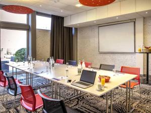 a conference room with a table with a laptop on it at Ibis Cavaillon Portes du Luberon in Cavaillon +110 photos
