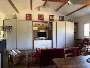 a living room with a couch and a tv at ATELIER Gîte Cahors in Pradines