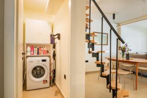a laundry room with a washer and dryer next to a table at Ble city in Karpathos