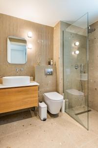 a bathroom with a toilet and a sink and a shower at Ble city in Karpathos +50 photos