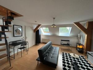 a living room with a couch and a table at Stadtloft am Schillerpark in Dessau
