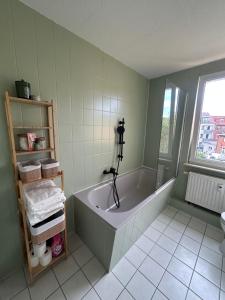 a bathroom with a large tub in a room at Stadtloft am Schillerpark in Dessau