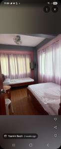 a bedroom with a bed and a bench in it at Yasmin's Transient House in Pagudpud +10 photos