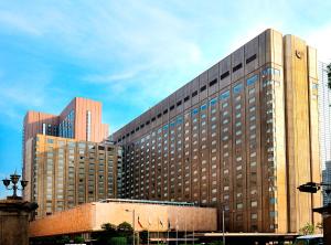 a large building with many windows in a city at Imperial Hotel Tokyo in Tokyo
